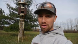 man standing in front of diy deer stand platform