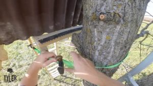 ratcheting bottom of diy deer stand against tree