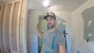 man standing in unfinished bathroom